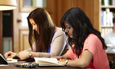 Two students studying in one of Oxford's libraries